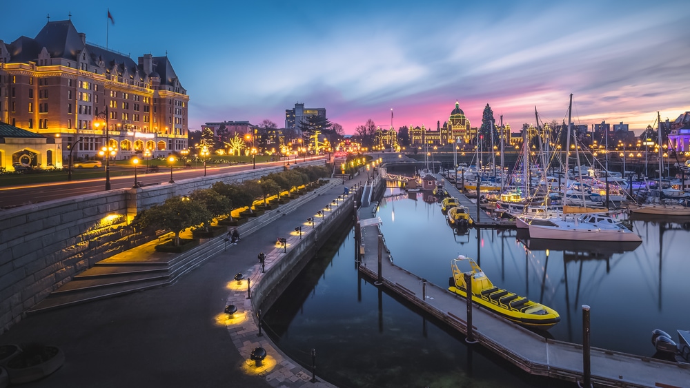Sunset cityscape panoramic view of the Inner Harbour, the Fairmont Empress Hotel and the Legislative Assembly of British Columbia in Victoria, B.C, Canada during Christmas Holidays. Haunted places in Canada