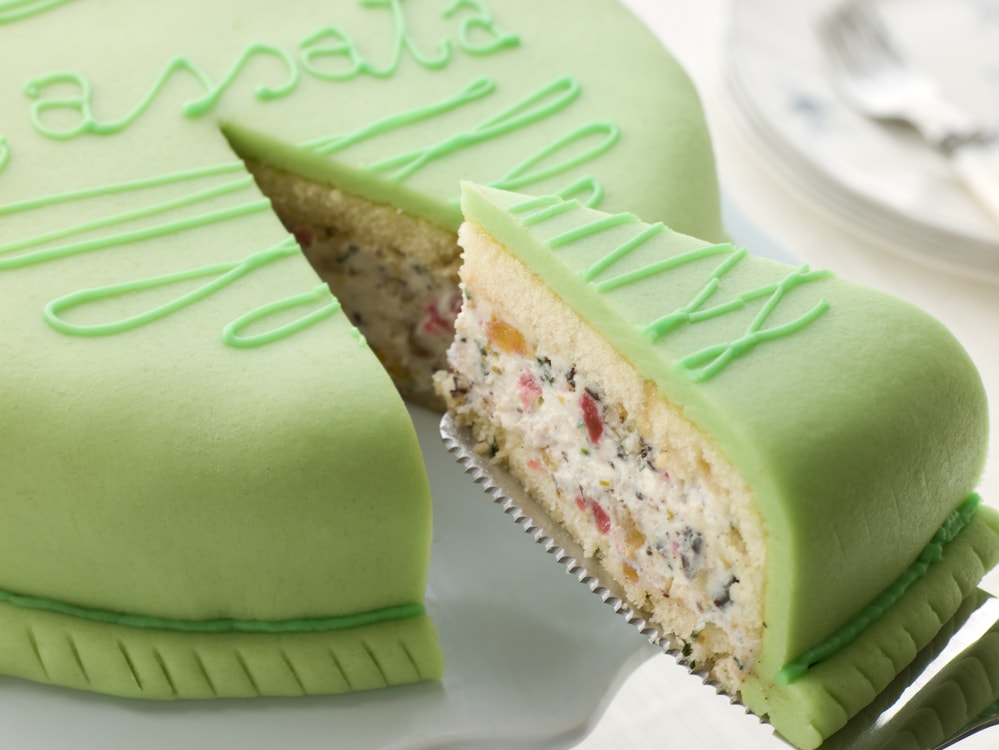 Cassata cake with slice being removed