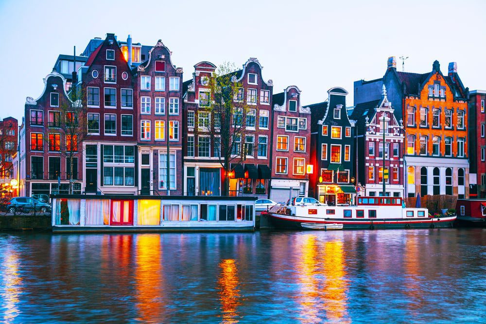 Night city view of Amsterdam, the Netherlands with Amstel river