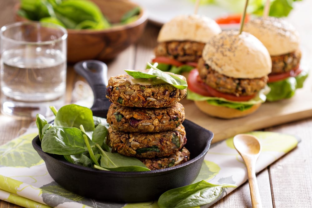 Vegan burgers with  beans and vegetables served with spinach