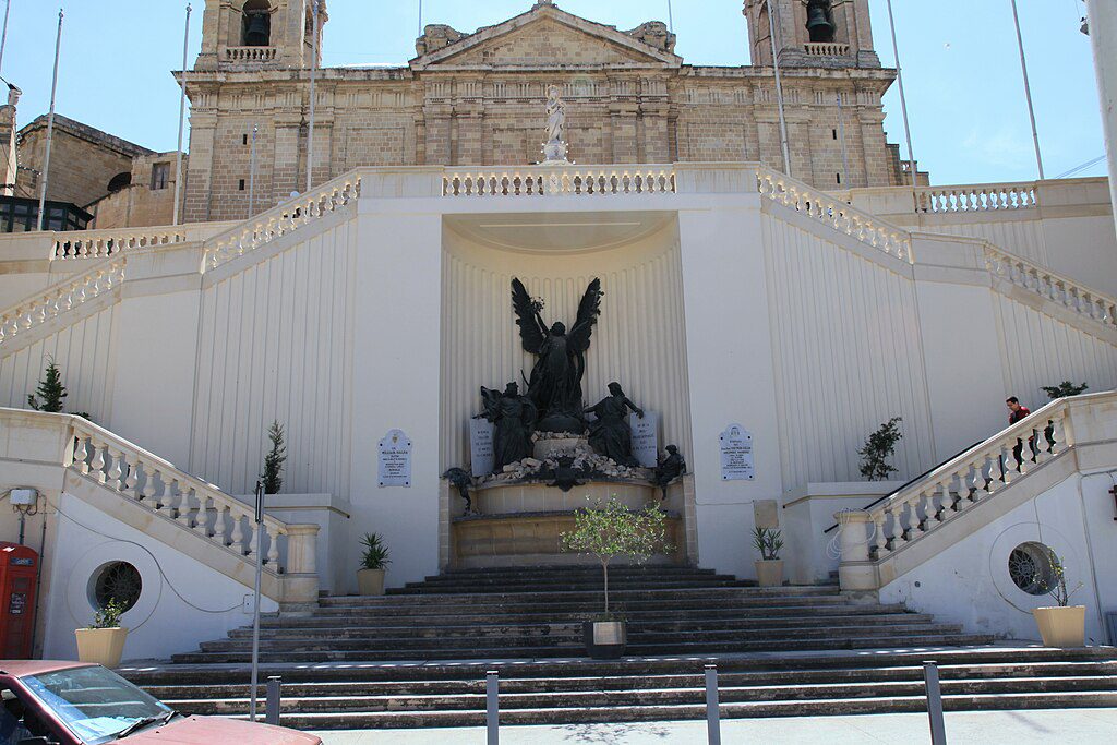 Church of Our Lady of the Immaculate Conception a white building with staircases going up either side and a giant angel statue centred in a niche between the stairs