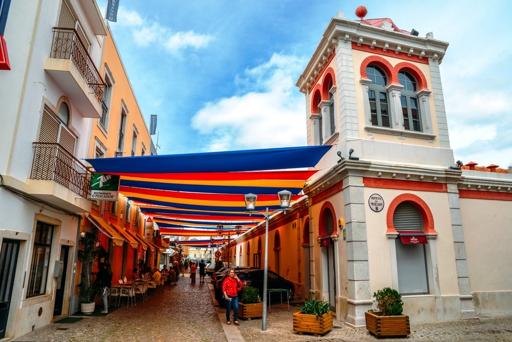 Loule, Portugal - June 4, 2018: Moorish architectural facade of the traditional market consisting of family run stalls selling local grown or sourced produce which include fish, fabrics and gifts