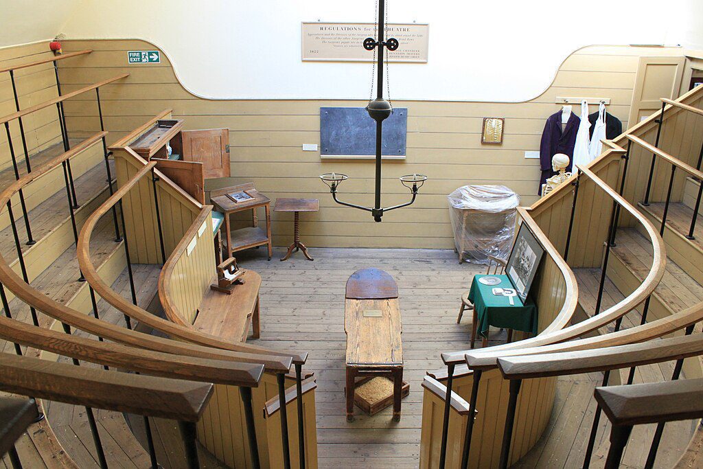 The old operating theatre in the museum. Wooden benches rise up around the round floor area where an old operating table sits