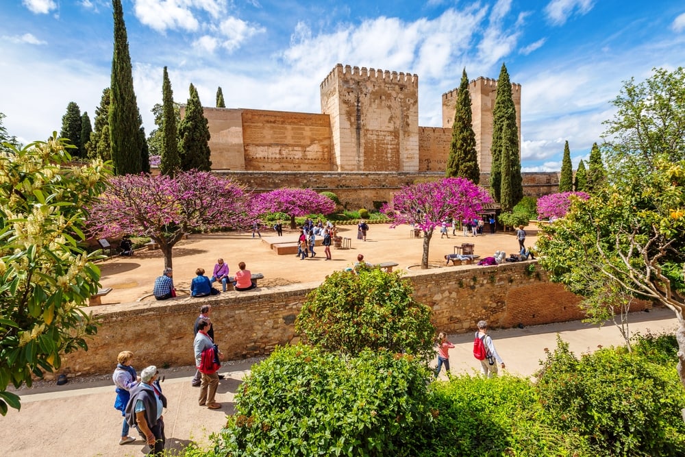 Granada, Andalucia, Spain - April 17, 2016: people and tourists around the Alcazaba de Granada, the military fortress of the Alhambra, in a sunny day. Article digital nomad visa in Europe