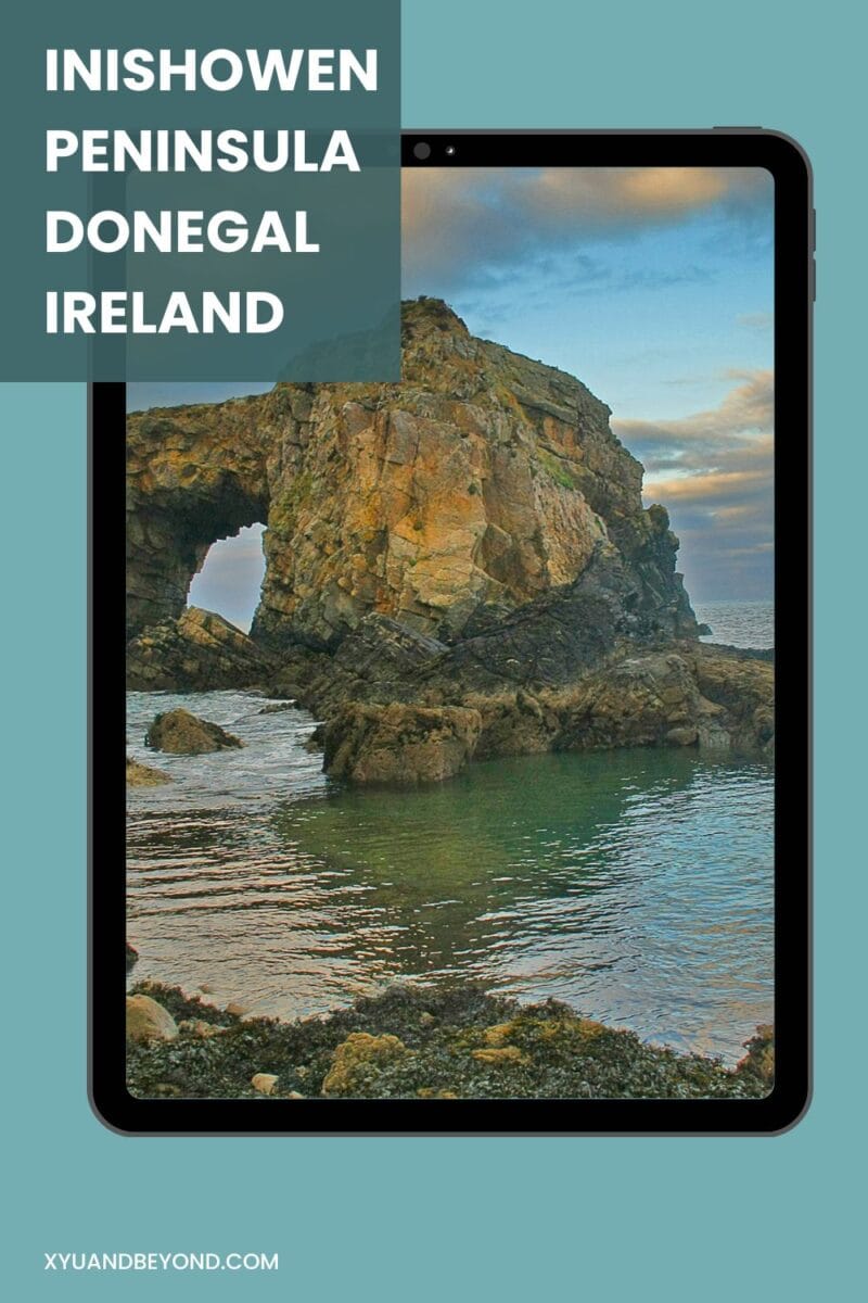 A tablet displaying an image of a rocky arch formation on the Inishowen Peninsula in Donegal, Ireland, with promotional text overlay about things to do in Inishowen.