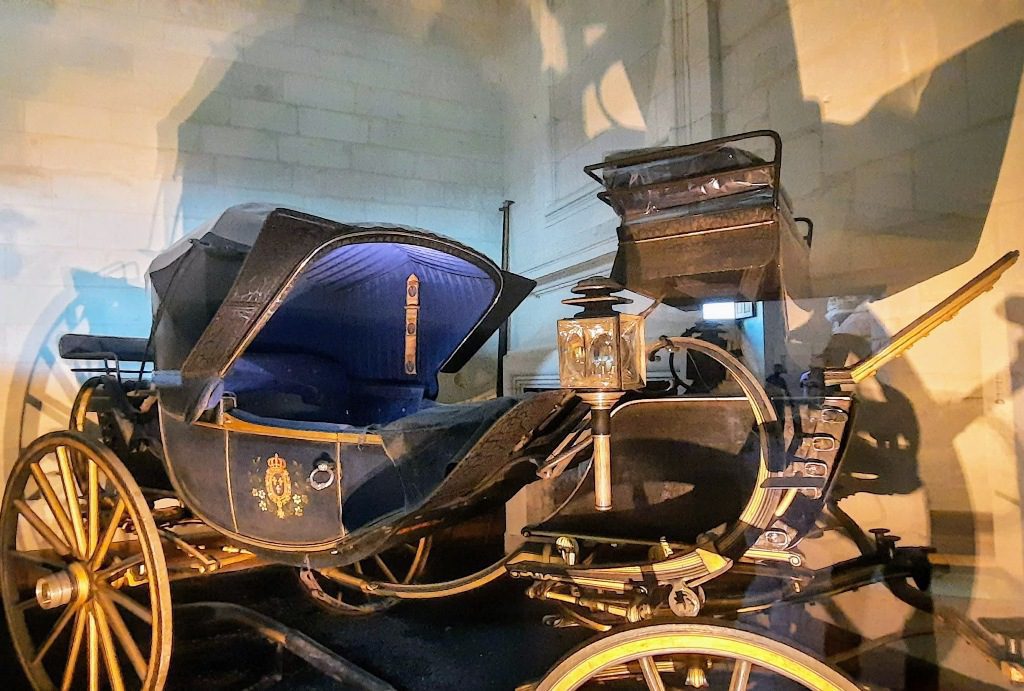 Carriage room at Chambord Castle with a black and gold cartouche a carriage for showing off in