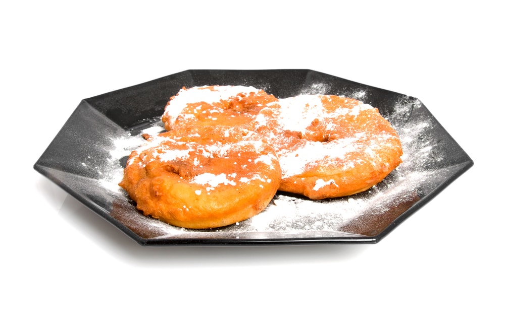 plate with home baked appelflappen ( apple fritter), typical dutch food