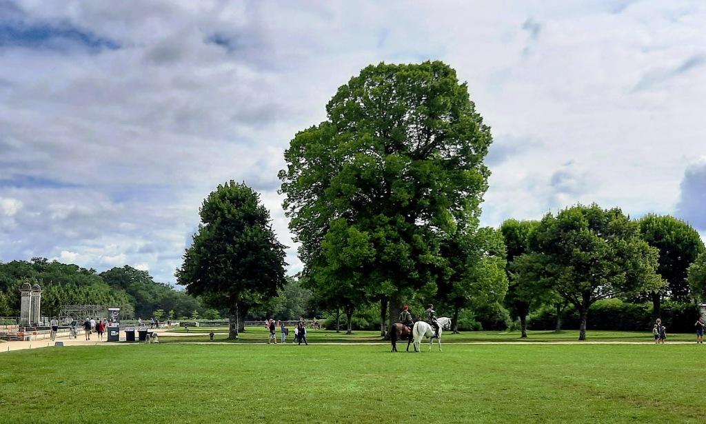 Riders in the Gardens of Chambord dressed in Renaissance costumes riding horses