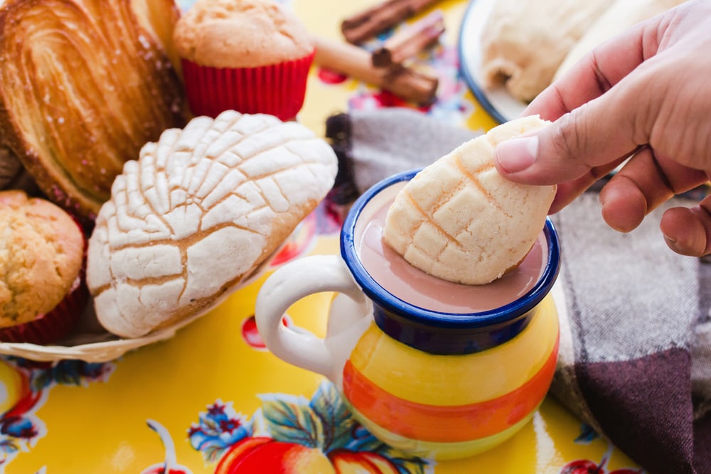 Concha and chocolate, mexican sweet bread and atole beverage in mexico breakfast