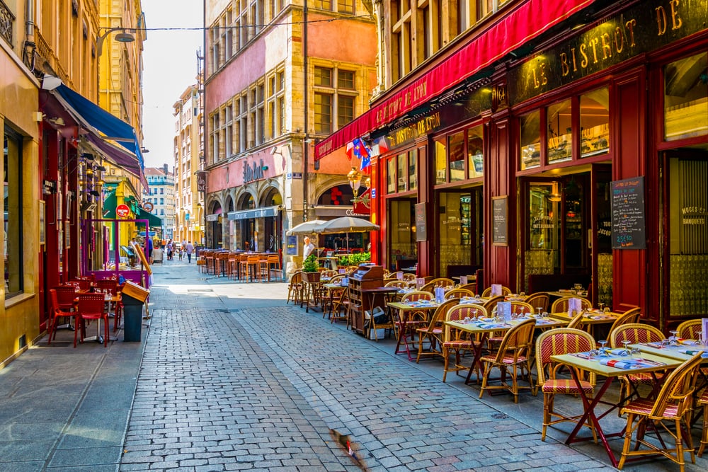 LYON, FRANCE,  a narrow street full of restaurants is waiting for first customers to come, Lyon, France
