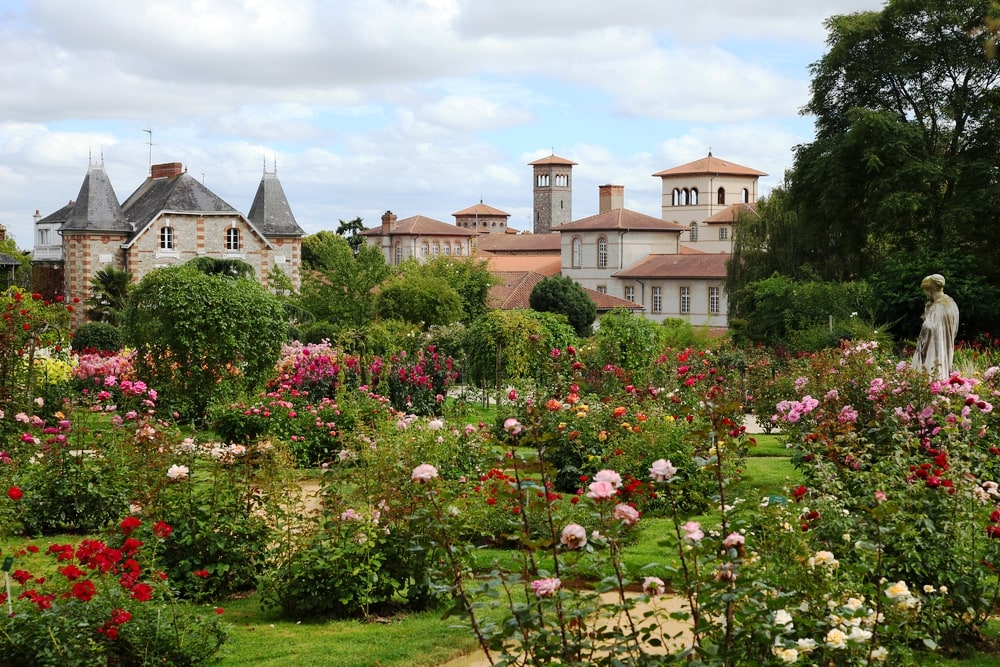 Beautiful views of the flowering garden and old town in Rennes in France
