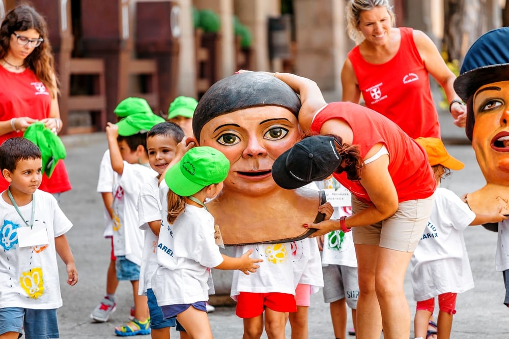 Pros and cons of Living in Spain BARCELONA, SPAIN: Children at Giant figures Festival in Poble Espanyol main square