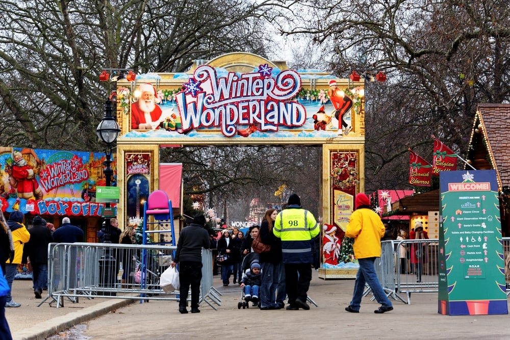 Winter Wonderland in Hyde Park, London. The front gate of Hyde Parks Winter Wonderland with guests going through to enjoy the Christmas Market