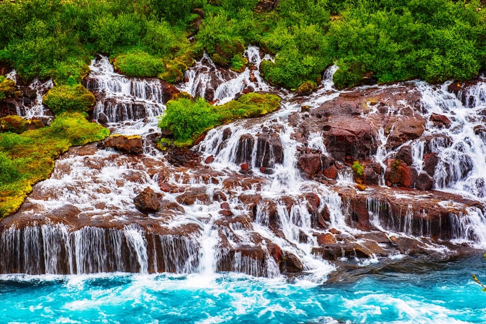 Hraunfossar series of waterfalls formed by rivulets streaming over a distance of about 900 metres. Iceland travel destination