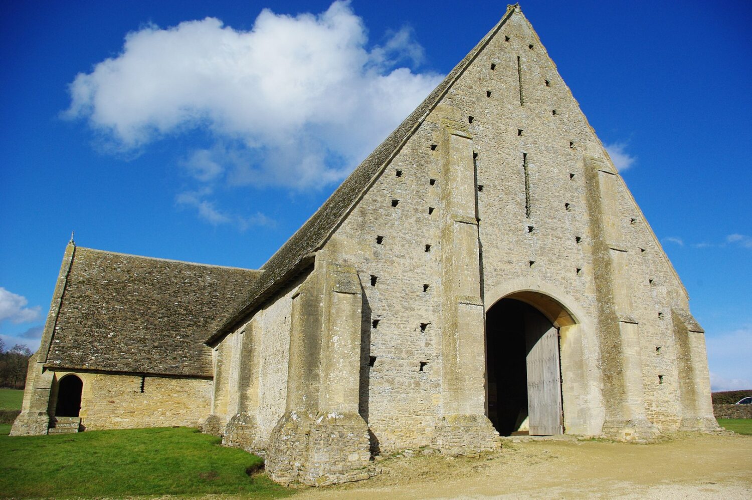 Great Coxwell Barn is a white peaked building