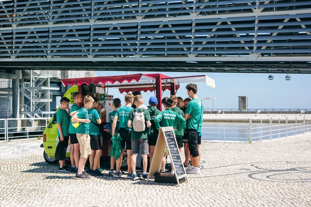pupils at street buy street food or fresh juice. School pros and cons of living in Portugal