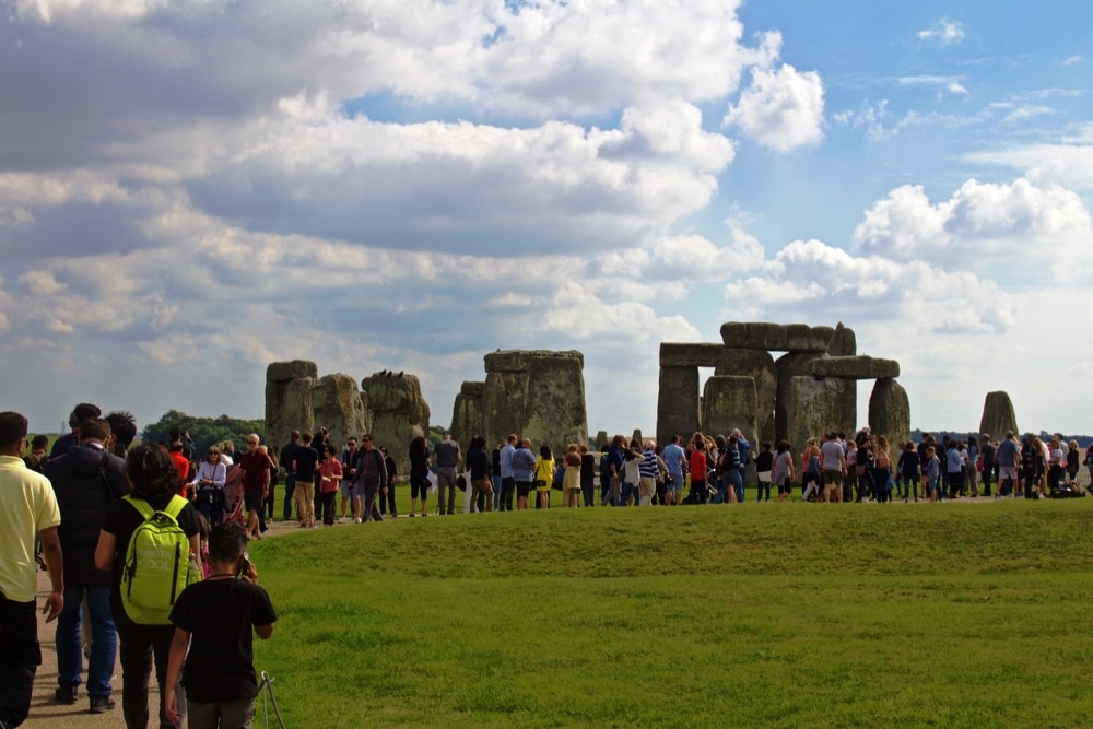 Amesbury, United Kingdom- September 2018, Crowd Stands in Front of the Rocks of Stonehenge On a Cloudy Summer Day