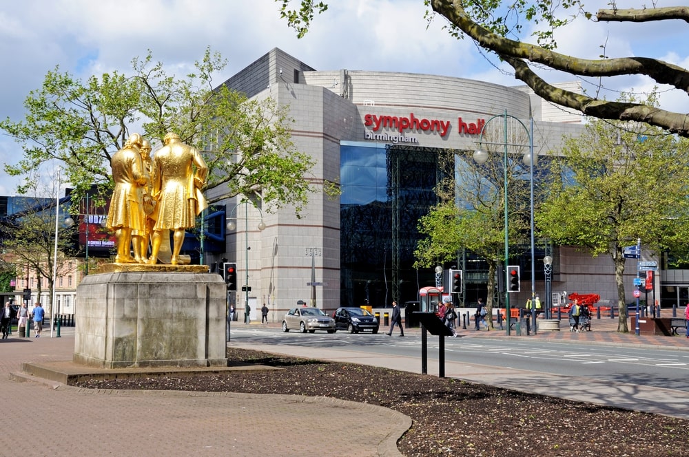 Statue of Matthew Boulton, James Watt, and William Murdoch by William Bloye with the Symphony Hall to the rear, Broad Street, Birmingham, England, UK, Western Europe.