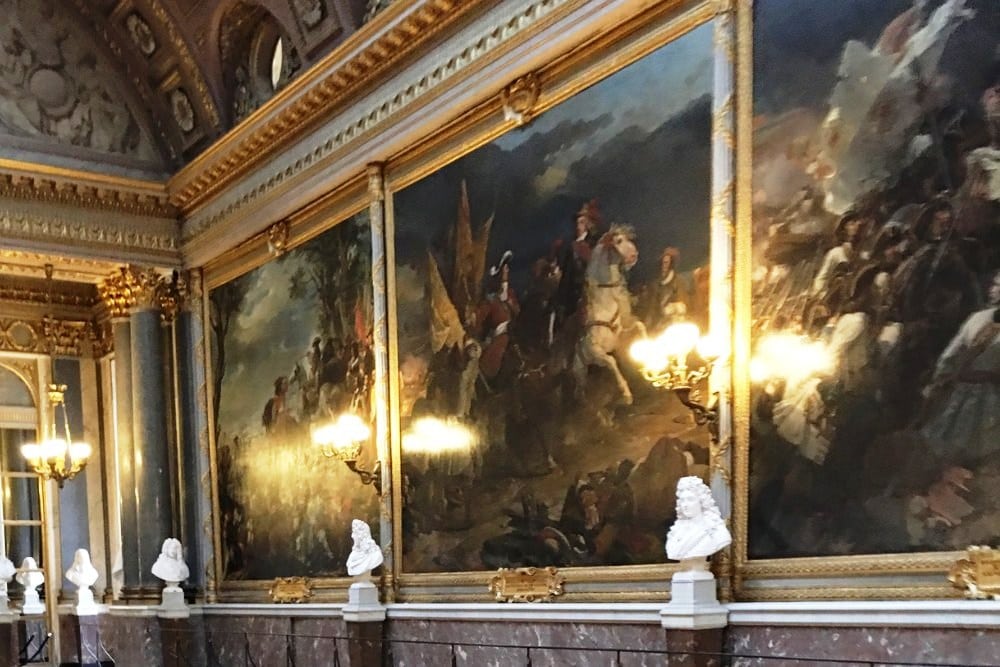The Gallery of Great Battles in the Palace of Versailles. Massive portraits and white marble buts tell the stories of Frances greatest military wars and battles