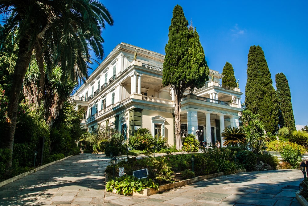 One of the best things to do in Corfu is visit the Achilleion Palace surrounded by palm trees. It was built by Empress of Austria, Elisabeth of Bavaria, also known as Sisi in 1890.