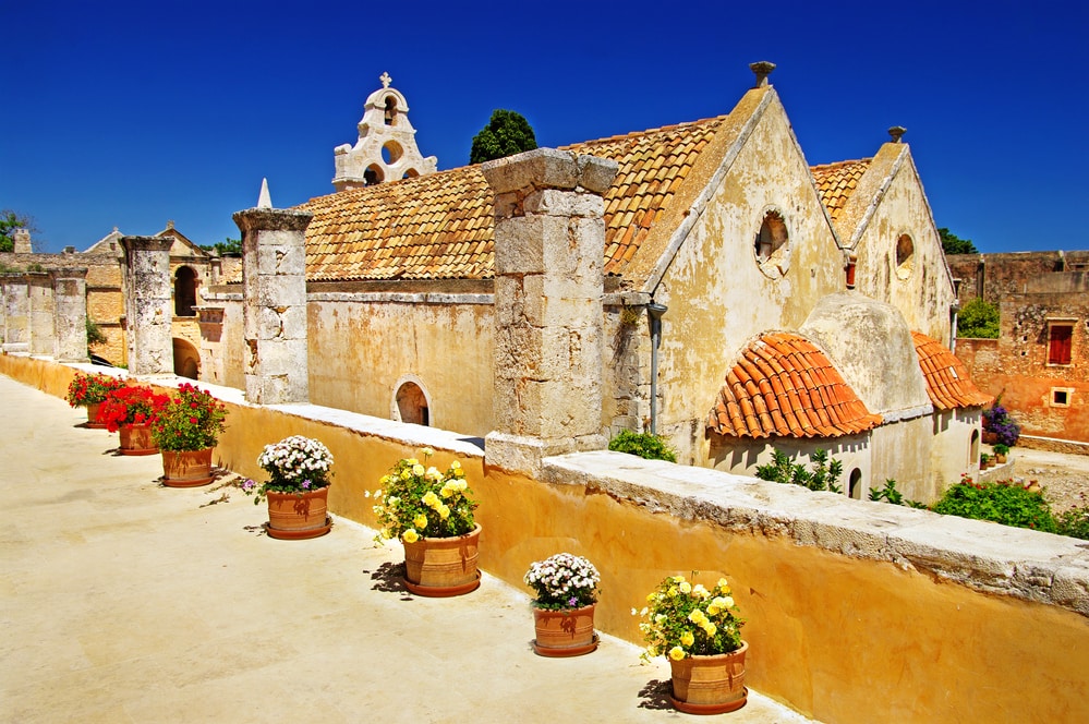 A row of potted flowers in front of a building, adding beauty to the charming cityscape of Chania. The Arkadi Monastery