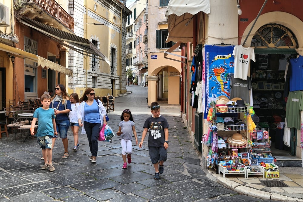 One of the best things to do in Corfu is strolling down a cobblestone street with a group of people. People visit Corfu Town in Greece. The Old Town of Corfu is a UNESCO World Heritage Site.