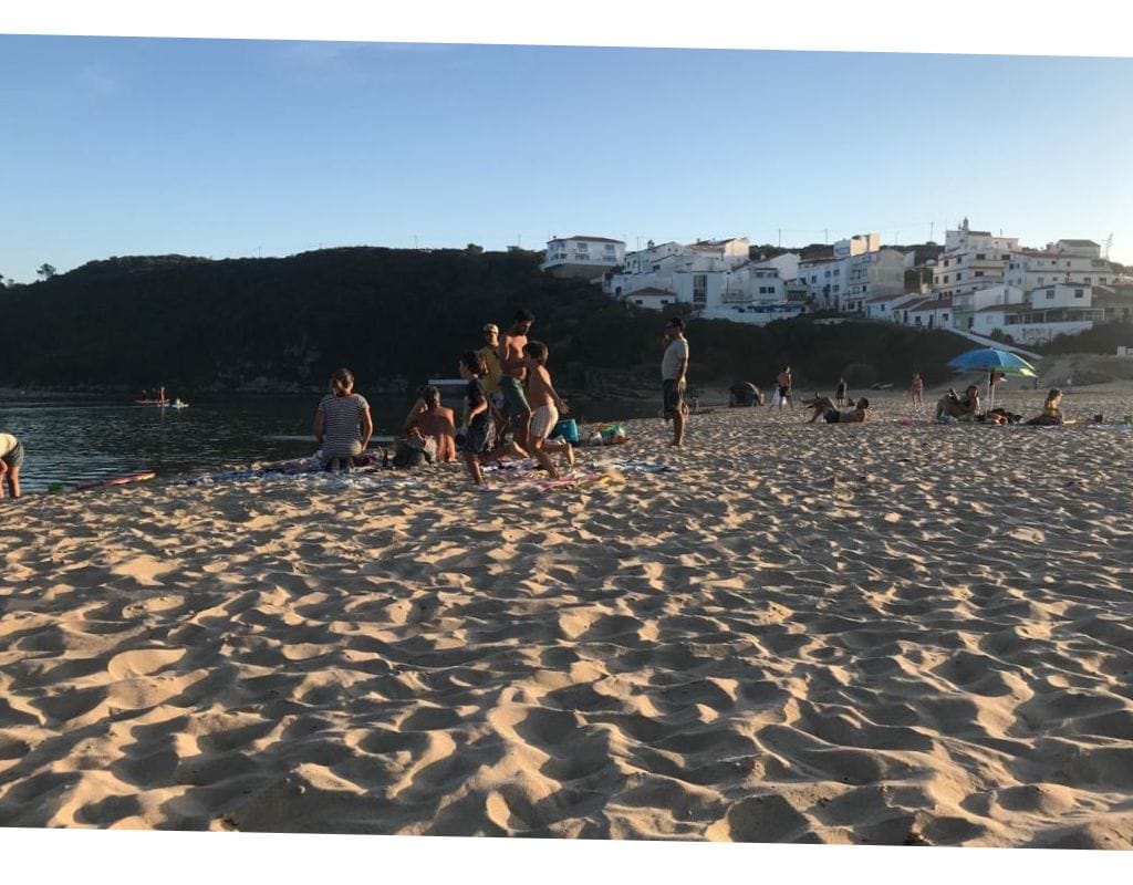 A group of people enjoying one of the best beaches in Portugal.