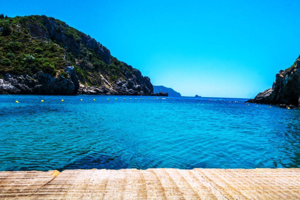 One of the best things to do in Corfu is walk along a wooden path that stretches out to the crystal-clear blue ocean.