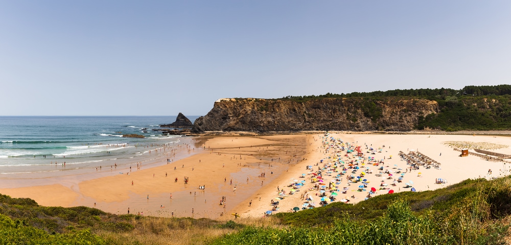 Odeceixe, Portugal - the Odeceixe beach.. One of the best beaches in Portugal, this sandy beach is bustling with people enjoying the sun and sea.