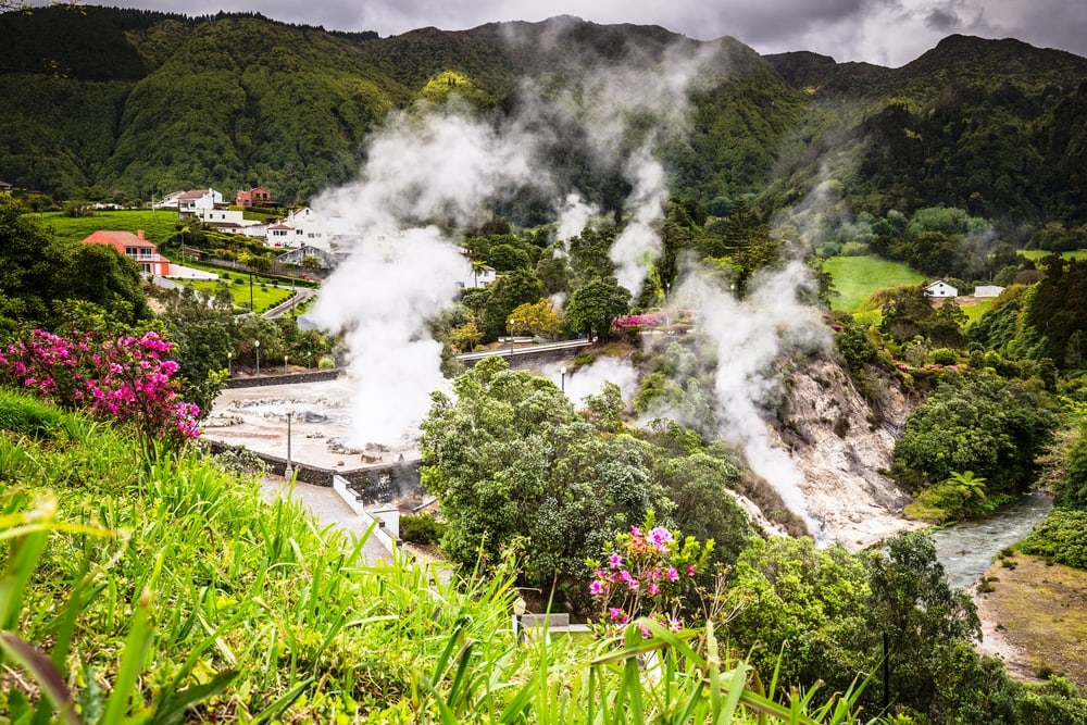 Hot spring waters in Furnas, Sao Miguel. Azores. Portugal A Lush valley hot springs surrounded by green grass and flowers.