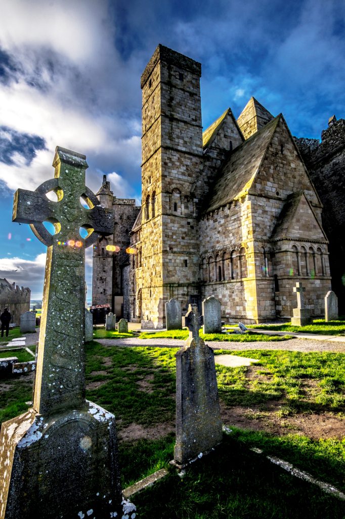 Cross on Rock of Cashel with cloudy background in Ireland