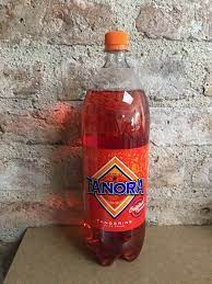 A bottle of tanora soda sitting on top of a traditional Irish food.