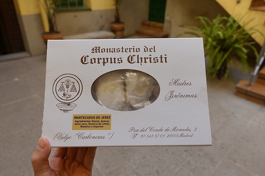 A person holding a box of "mantecados de jerez" from the Monasterio del Corpus Christi during one day in Madrid.