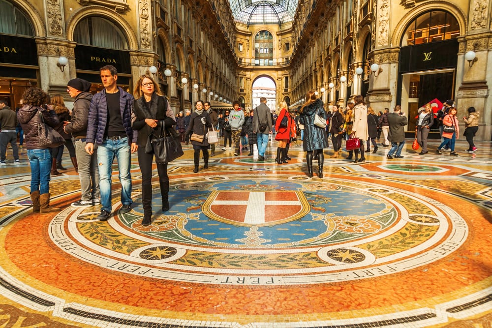 A group of people standing in an ornately decorated shopping mall, one of the best places to visit in Italy.