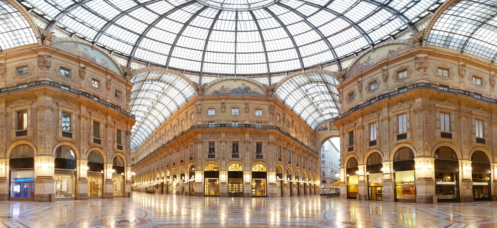 The interior of a shopping mall with a glass ceiling, regarded as one of the best places to visit in Italy.