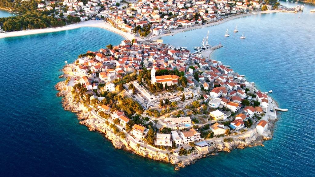 Aerial view of a picturesque coastal town on a peninsula at sunset, showcasing things to do in Split, Croatia.