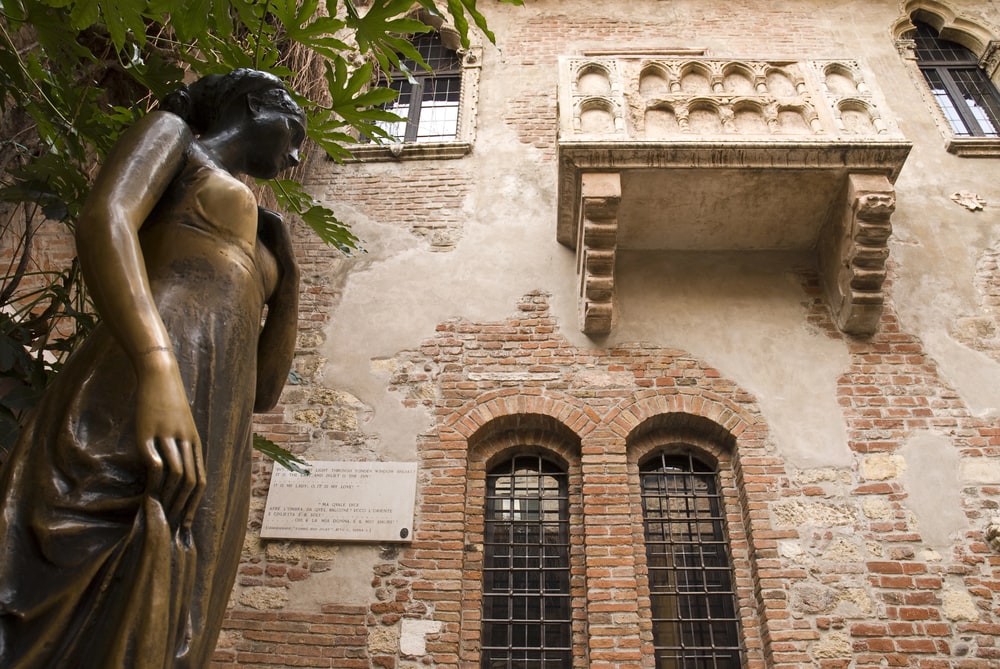A statue in front of a building, among the best places to visit in Italy.