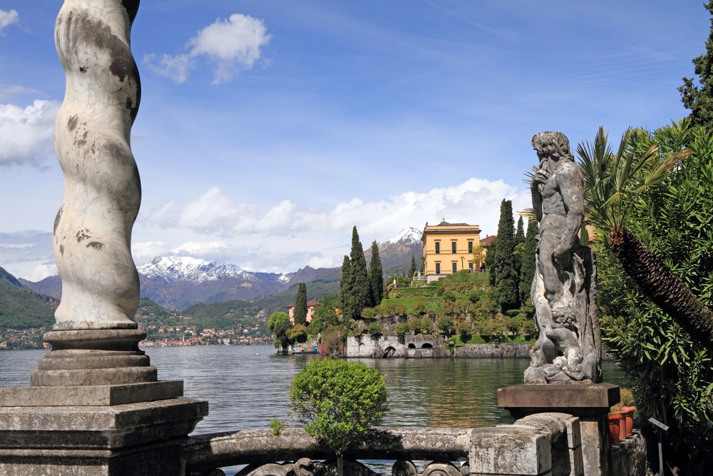 A statue of a woman by a lake in one of the best places to visit in Italy.
