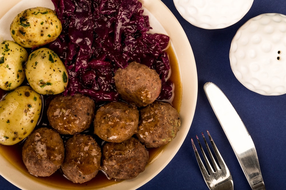 A plate with meatballs, potatoes, and red cabbage is a classic food in Norway.
