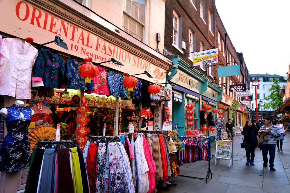 Visitors in Chinatown in  City of Westminster London.It contains a number of Chinese restaurants, bakeries, supermarkets, souvenir shops, and other Chinese-run businesses.