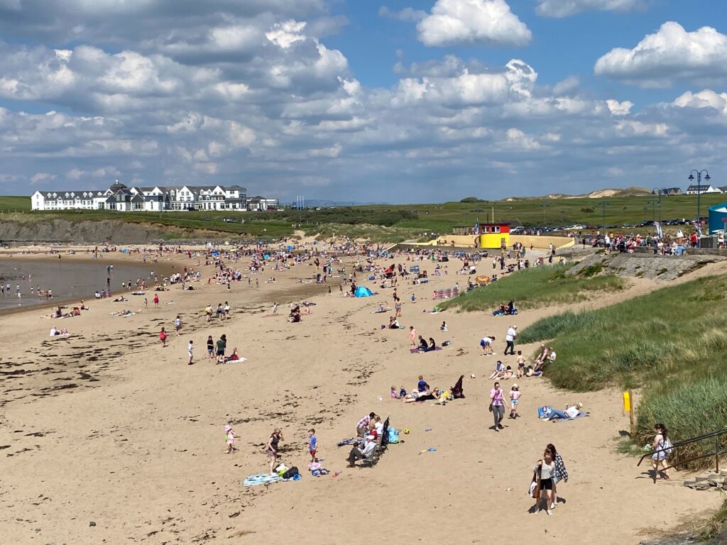 Bundoran Main Beach with sunbathers and swimmers on the golden sand