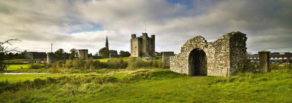 Trim Castle Trim, County Meath, Ireland. Green grass and cloudy sky. Morning.