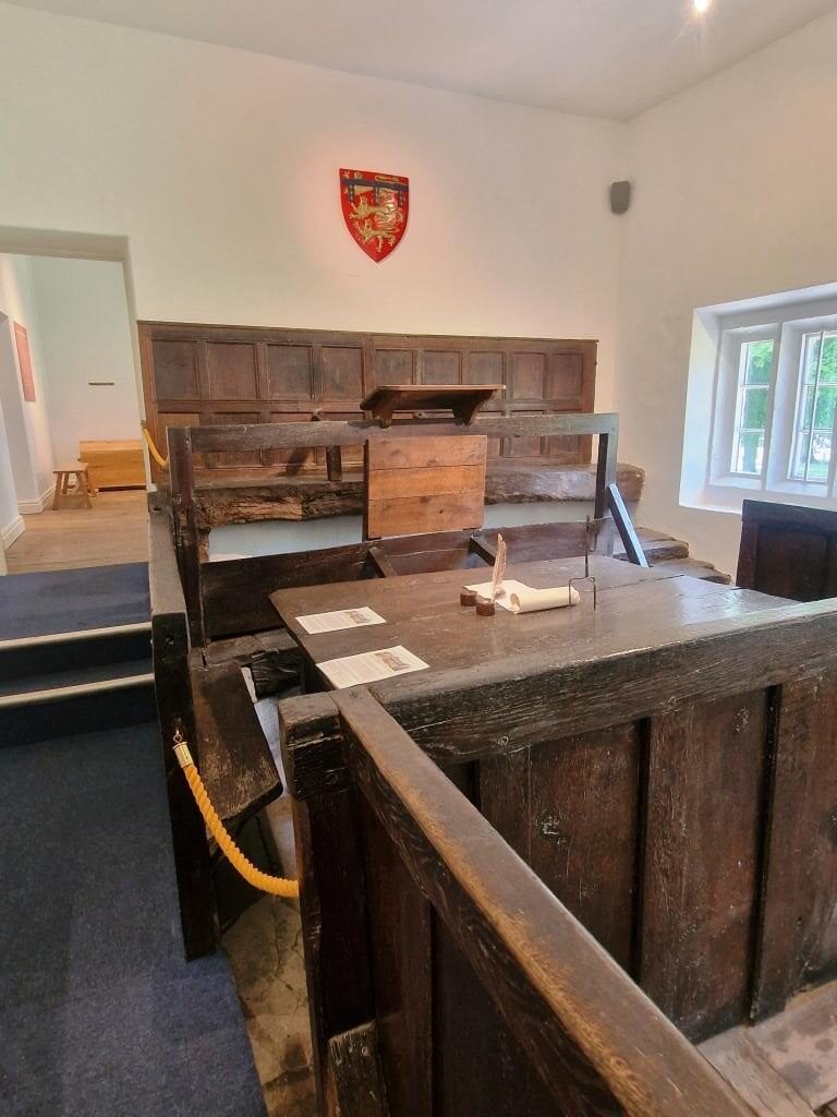 The original tudor courtroom at Knaresborough castle museum. Strong and sturdy seat for the judge with an oak panelling and a lecturn to judge from