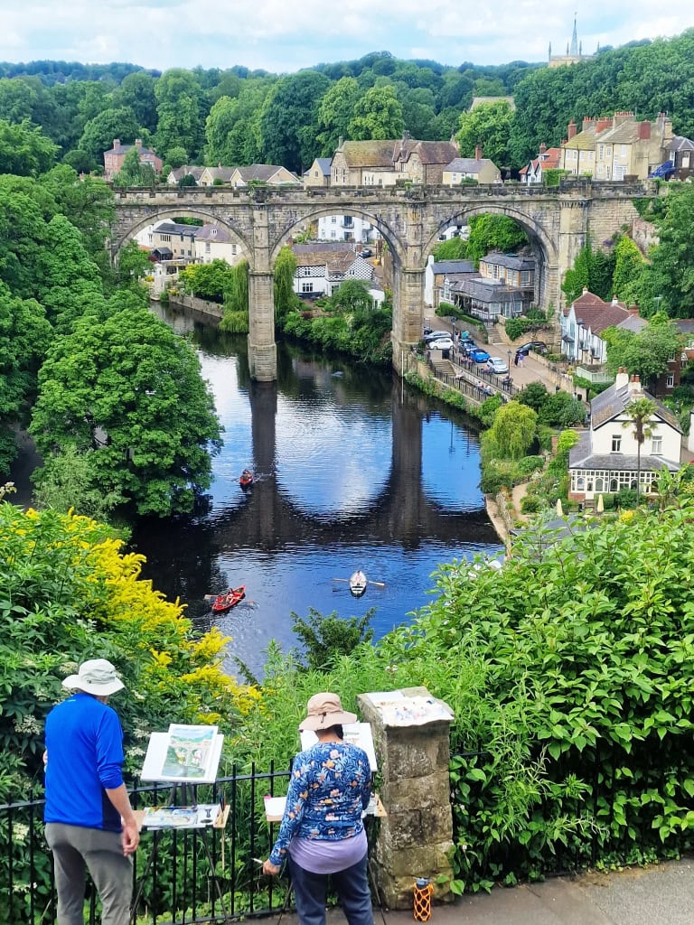 two artists painting the Knaresborough Viaduct view from the walkway beneath the castle grounds.