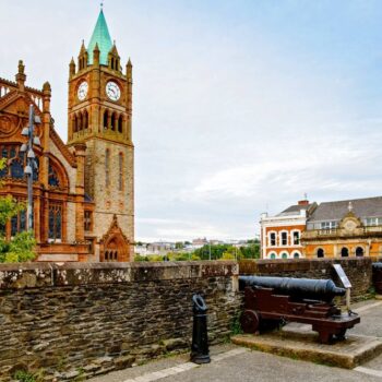 Derry, North Ireland. Aerial view of Derry Londonderry city center in Northern Ireland, UK. Sunny day with cloudy sky, city walls and historical buildings.