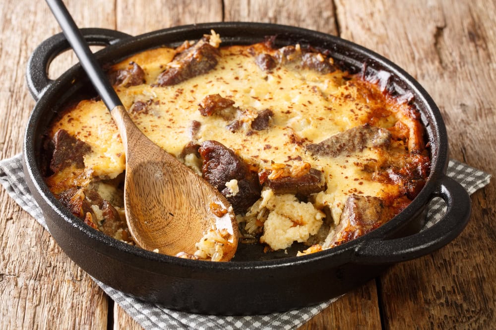 Tave kosi baked lamb and rice with yoghurt close-up in a pan on the table