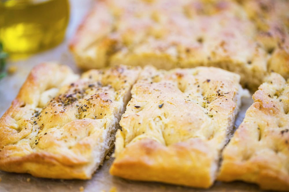 Focaccia bread with oregano and olive oil.Fresh italian foccacia bread closeup with mediterranean ingredients