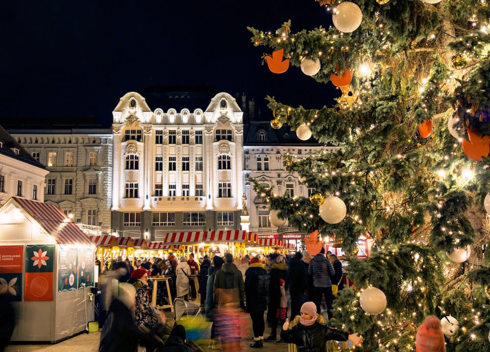 Christmas in Bratislava a Christmas market in old town with twinkling lights, Christmas trees and crowds of people