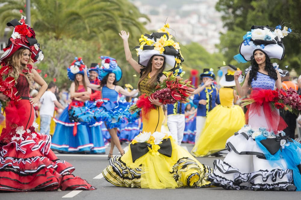 women dressed in colorful clothes at the Festa da Flor or Spring Flower Festival in the city of Funchal on the Island of Madeira in the Atlantic Ocean of Portugal.  Madeira, Funchal