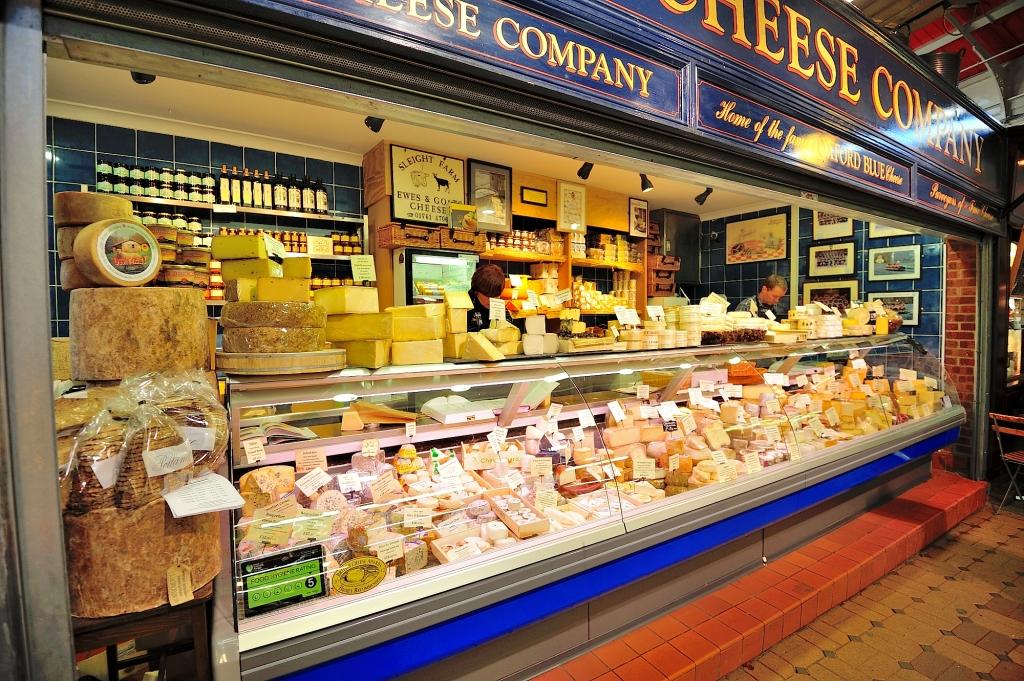 The Cheese Shop in Oxford a blue and white stand showcasing a myriad of British Cheeses